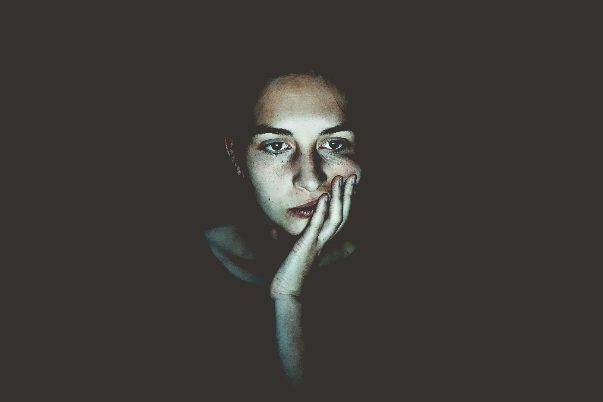 A girl sitting in dark background and worried about the Ethical AI in PMO Outsourcing