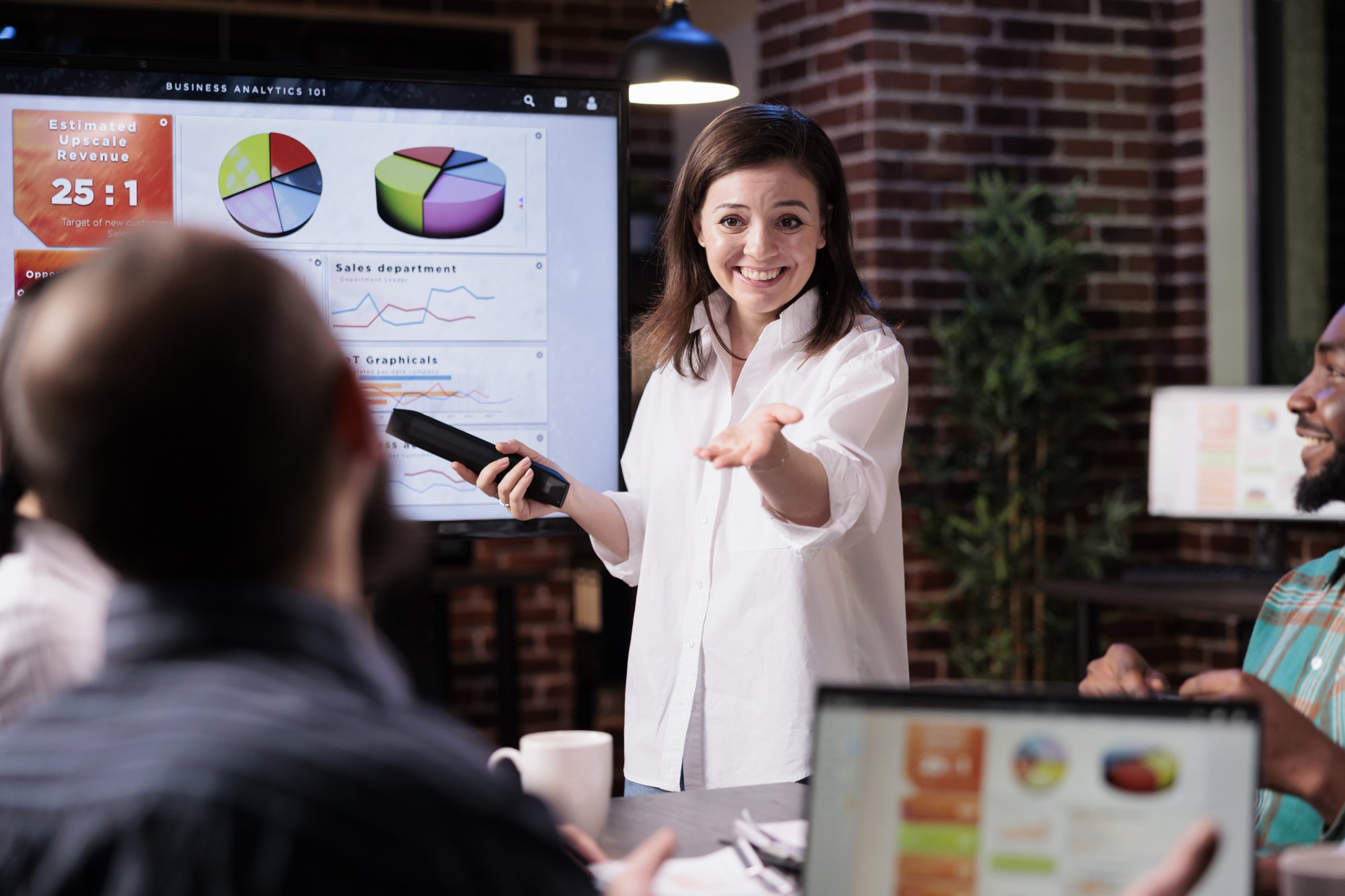 Smiling business woman in a presentation showing soft skills in project management