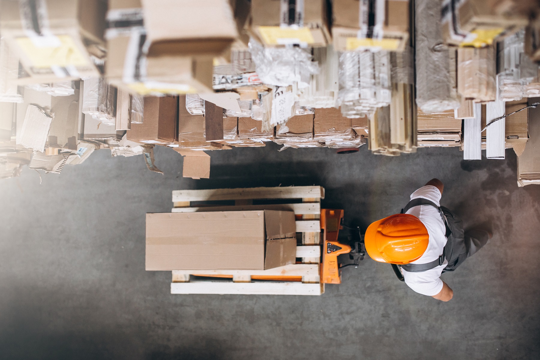 Young man working at a warehouse with boxes showing the importance of procurement planning in project management