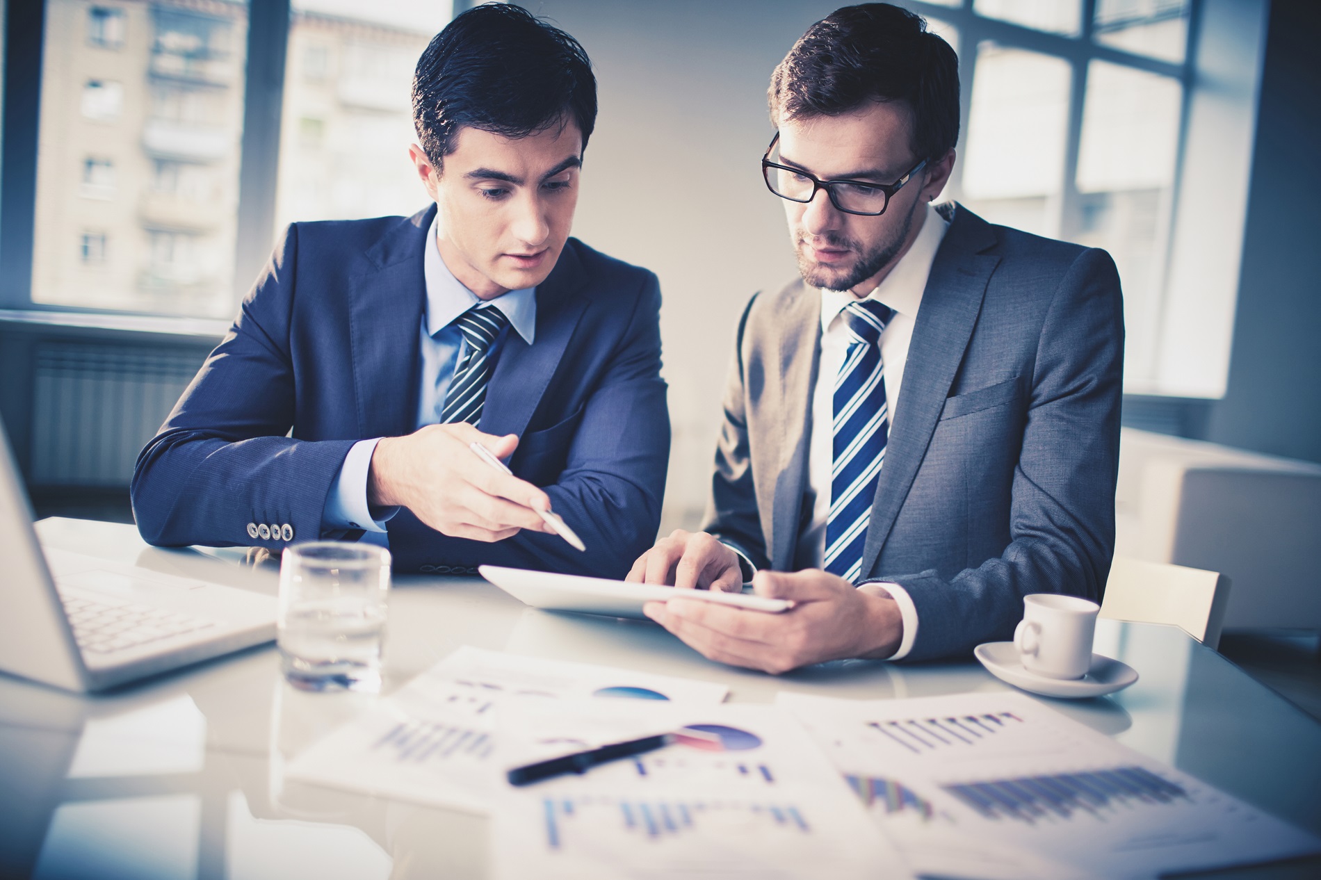 Image of two young businessmen discussing management consultancy services in saudi arabia